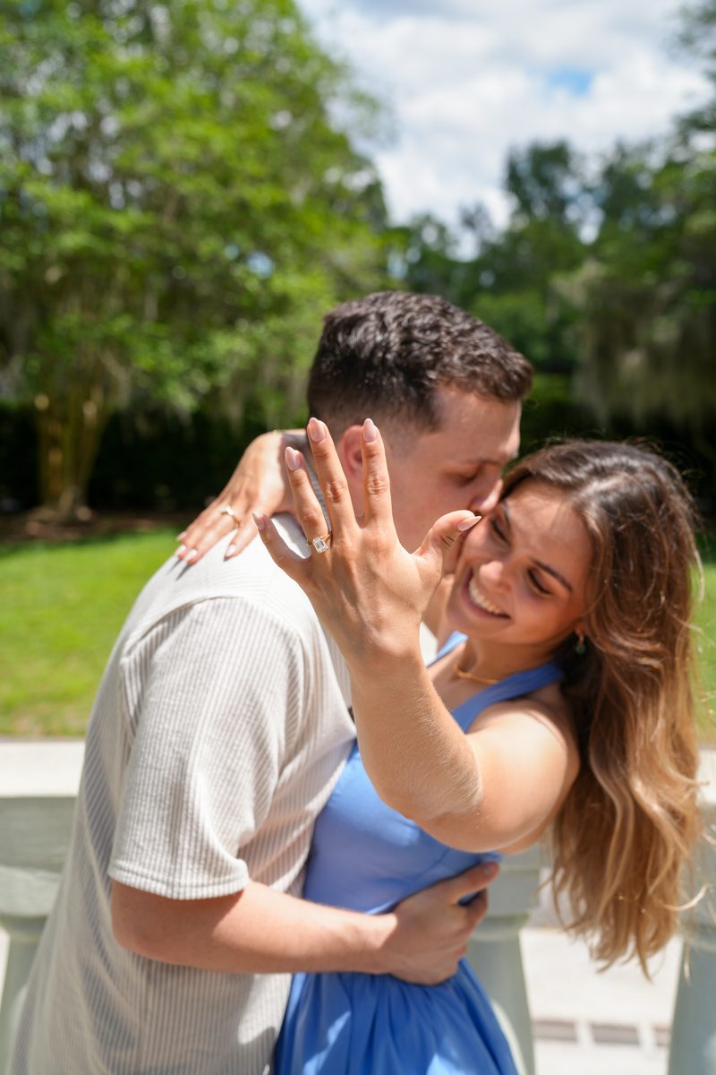 Close-up of the new ring and her smile as they embrace.