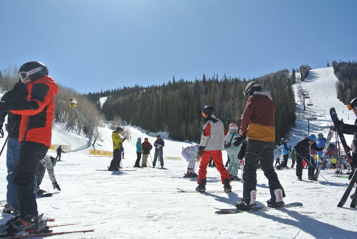 Skiers on a sunny slope in Utah.